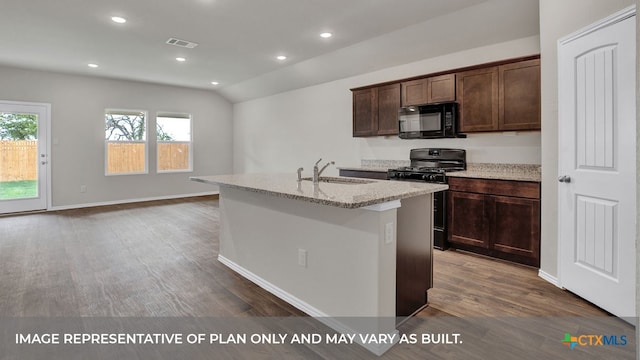 kitchen with dark hardwood / wood-style flooring, black appliances, a healthy amount of sunlight, and an island with sink