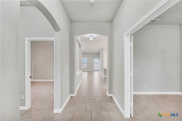 hall featuring light tile patterned floors