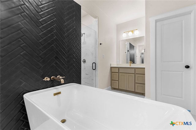 bathroom with vanity and independent shower and bath