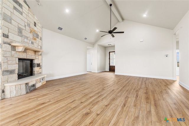 unfurnished living room featuring beamed ceiling, light hardwood / wood-style floors, a fireplace, and high vaulted ceiling