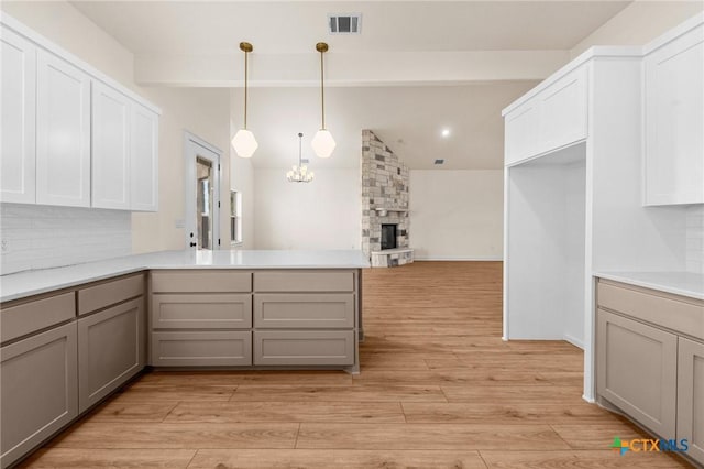 kitchen featuring gray cabinets, light countertops, and a peninsula