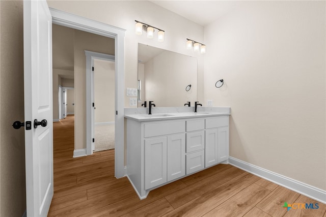 bathroom with hardwood / wood-style flooring and vanity