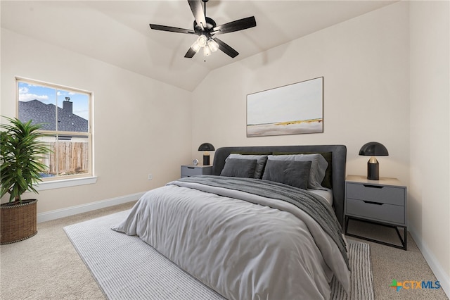 carpeted bedroom with ceiling fan and lofted ceiling