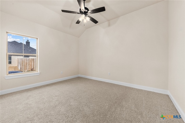 empty room with carpet flooring, ceiling fan, and lofted ceiling