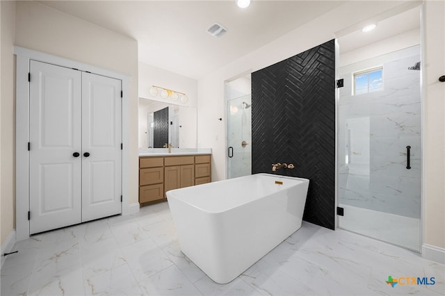 bathroom with shower with separate bathtub and vanity