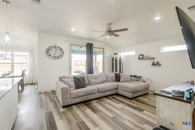 living room featuring light wood-style flooring and a wealth of natural light