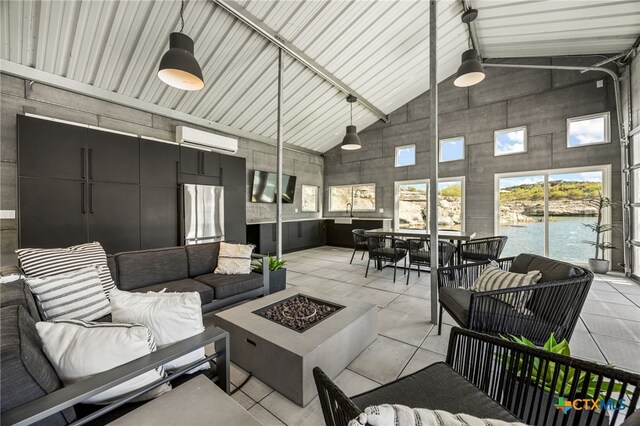 interior space with a wall unit AC and high vaulted ceiling