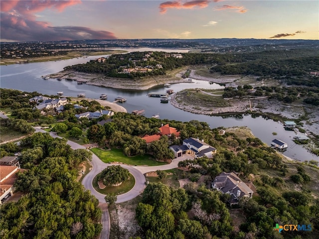 aerial view at dusk with a water view