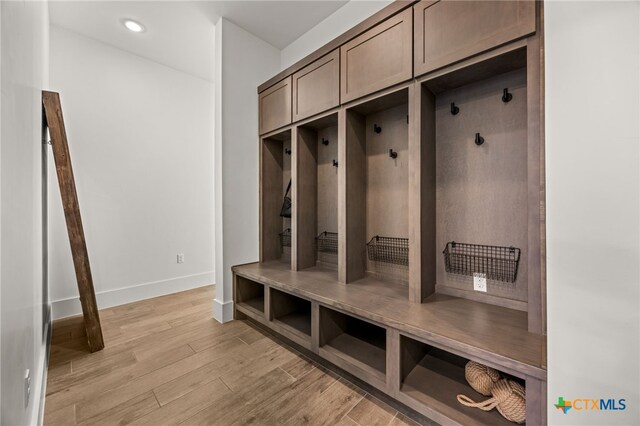 mudroom with light hardwood / wood-style floors