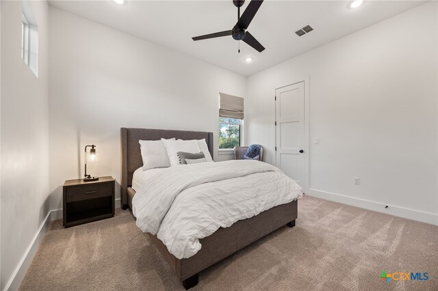 bedroom featuring light colored carpet and ceiling fan