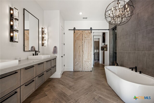 bathroom featuring vanity, parquet floors, and a bathtub