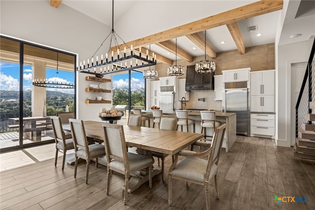 dining area with hardwood / wood-style floors, high vaulted ceiling, and beam ceiling