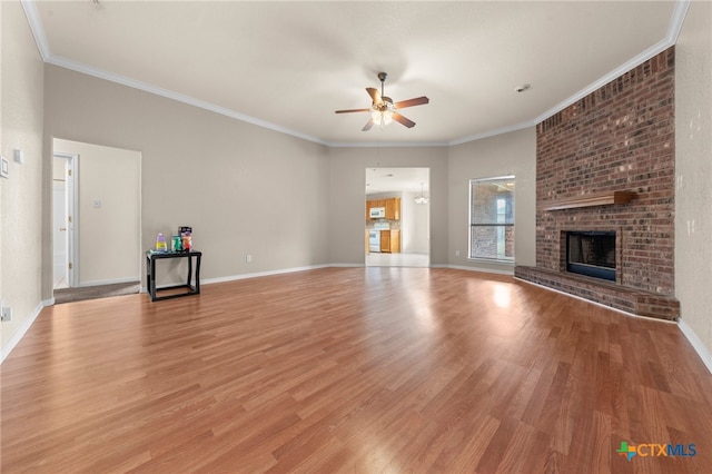 unfurnished living room with a fireplace, light hardwood / wood-style floors, ceiling fan, and ornamental molding