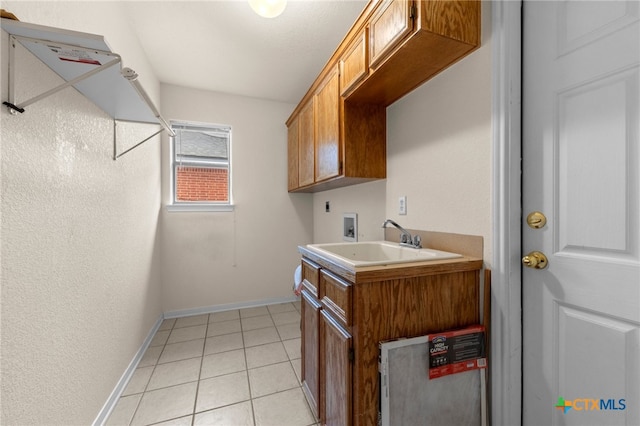 washroom featuring cabinets, light tile patterned flooring, sink, electric dryer hookup, and hookup for a washing machine