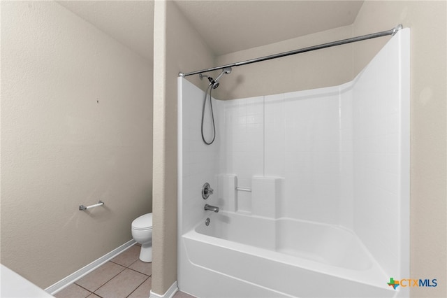 bathroom featuring toilet, tub / shower combination, and tile patterned flooring