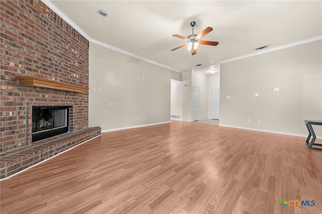 unfurnished living room featuring ornamental molding, light wood-type flooring, a fireplace, and ceiling fan