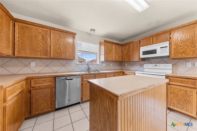 kitchen with a center island, light tile patterned floors, sink, backsplash, and white appliances