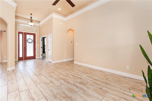 4360 Flint Oak Dr, Belton, TX 76513 - foyer with arched walkways, a ceiling fan, crown molding, baseboards, and a high ceiling