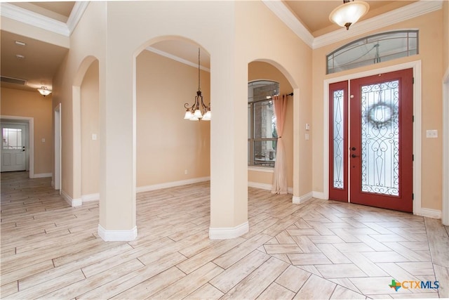 4360 Flint Oak Dr, Belton, TX 76513 - entrance foyer with a chandelier, arched walkways, crown molding, baseboards, and light wood finished floors