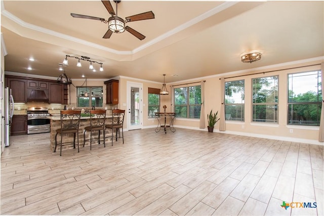 4360 Flint Oak Dr, Belton, TX 76513 - dining space featuring crown molding, a raised ceiling, ceiling fan, light wood-style flooring, and baseboards