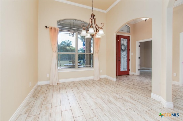 4360 Flint Oak Dr, Belton, TX 76513 - unfurnished room with arched walkways, crown molding, a chandelier, wood finished floors, and baseboards