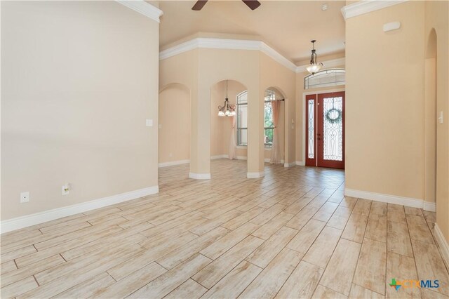 4360 Flint Oak Dr, Belton, TX 76513 - entryway featuring arched walkways, a chandelier, a ceiling fan, crown molding, and light wood-style flooring