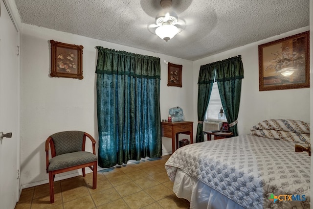 tiled bedroom with a textured ceiling and ceiling fan