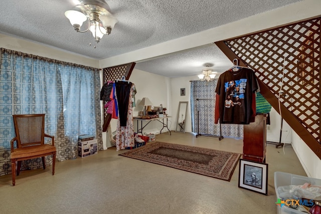 interior space featuring ceiling fan and a textured ceiling