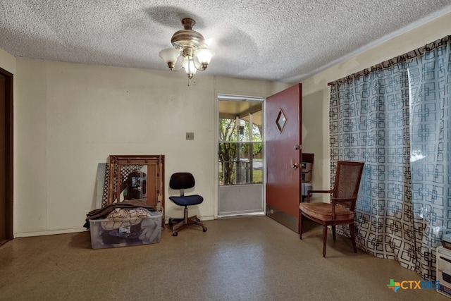 sitting room with a textured ceiling and ceiling fan