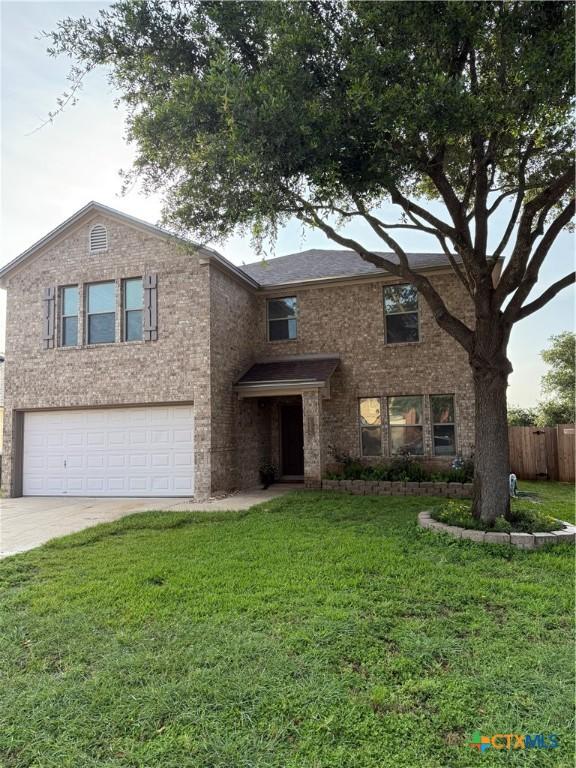 309 Fallen Leaf Ln, Temple, TX 76502 - view of front of home featuring a garage, concrete driveway, and brick siding