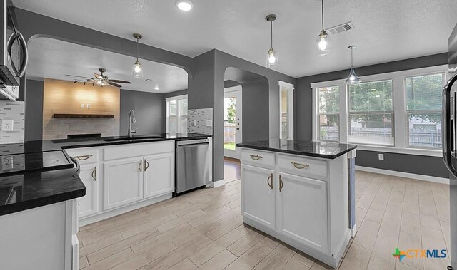 309 Fallen Leaf Ln, Temple, TX 76502 - kitchen with butcher block counters, white cabinets, tasteful backsplash, and a textured ceiling