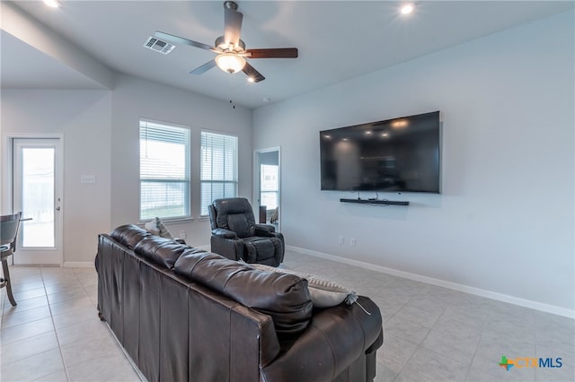 tiled living room with ceiling fan