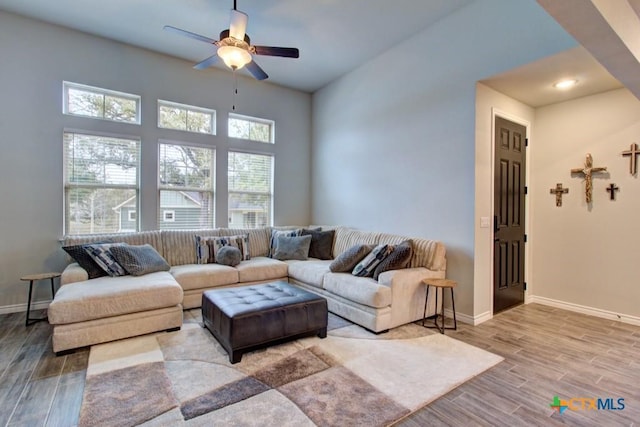 living room with ceiling fan and light hardwood / wood-style floors