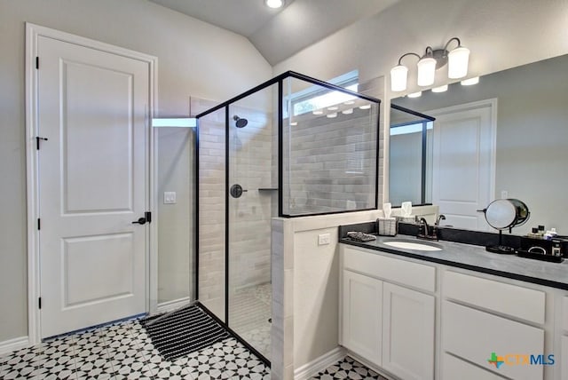 bathroom with vanity and a shower with shower door