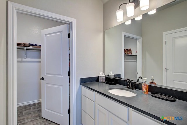 bathroom featuring vanity and hardwood / wood-style floors