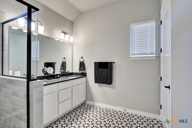 bathroom featuring vanity and a shower with shower door