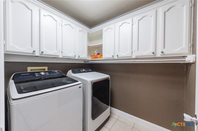 801 Arrowhead Dr, Salado, TX 76571 - laundry room with cabinet space, washer and clothes dryer, light tile patterned floors, and baseboards