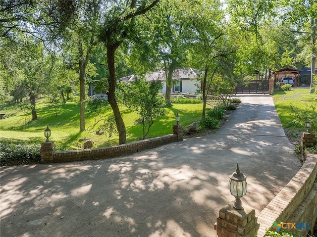 801 Arrowhead Dr, Salado, TX 76571 - view of community with a lawn, a gate, and view of scattered trees