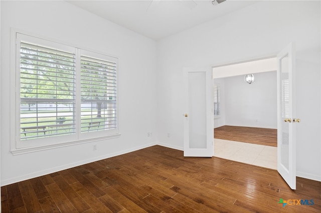 20904 Apache Plum Ln, Pflugerville, TX 78660 - empty room with wood finished floors, french doors, and baseboards