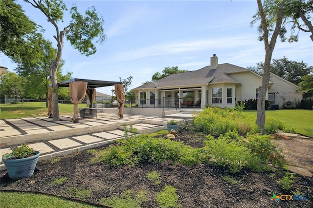 20904 Apache Plum Ln, Pflugerville, TX 78660 - rear view of property with a patio, a gazebo, and a chimney