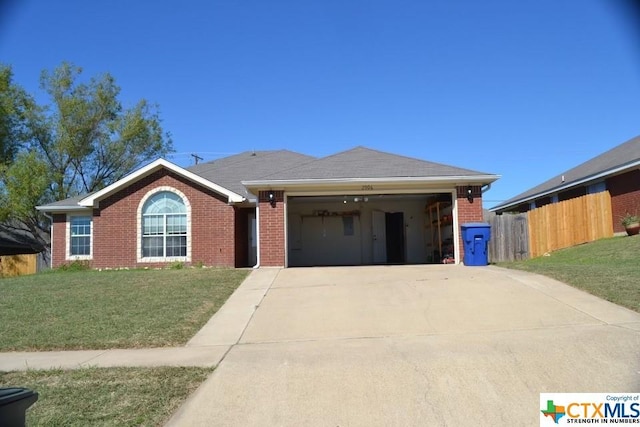 single story home with a front yard and a garage