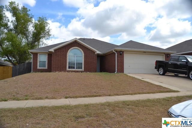 ranch-style home with a garage and a front lawn