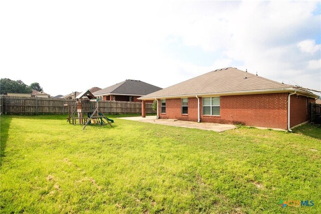 exterior space with a playground, a patio area, and a yard