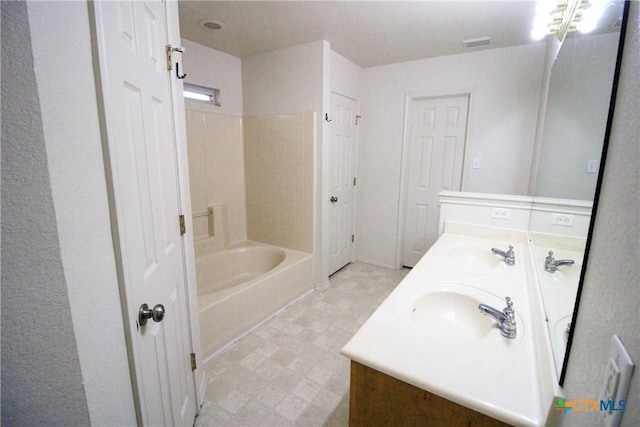 bathroom featuring vanity and bathing tub / shower combination