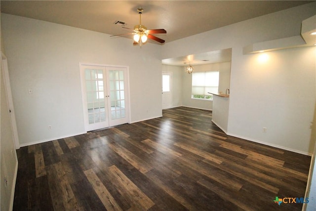 unfurnished room featuring french doors, ceiling fan with notable chandelier, and dark hardwood / wood-style floors