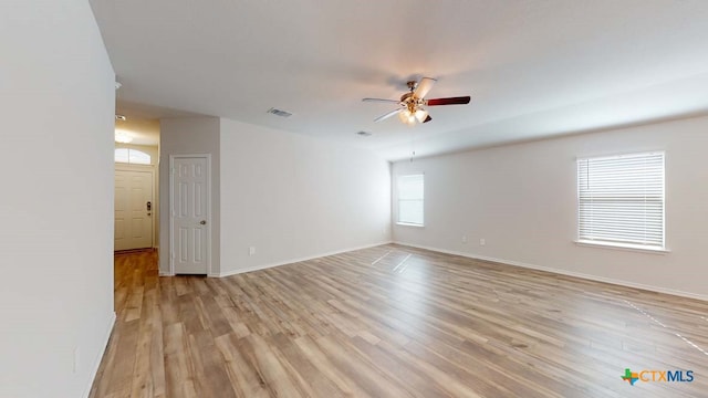 unfurnished room with ceiling fan and light hardwood / wood-style floors