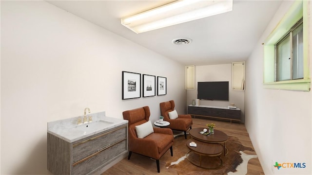 living area with visible vents and light wood-type flooring