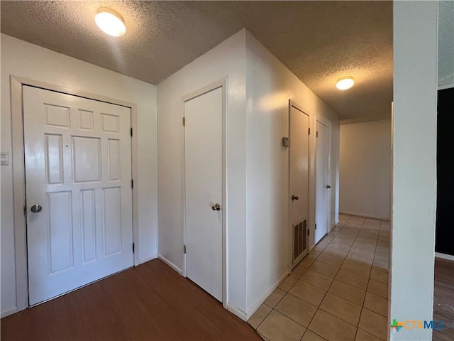 212 Brook St, Seguin, TX 78155 - corridor featuring a textured ceiling and light wood-style floors