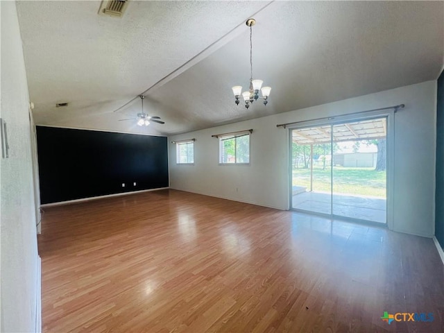 212 Brook St, Seguin, TX 78155 - spare room featuring lofted ceiling, a textured ceiling, light wood-style flooring, a chandelier, and a ceiling fan