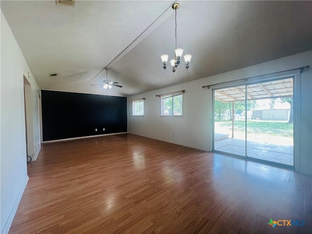 212 Brook St, Seguin, TX 78155 - unfurnished room with wood finished floors, vaulted ceiling, ceiling fan, a chandelier, and a textured ceiling